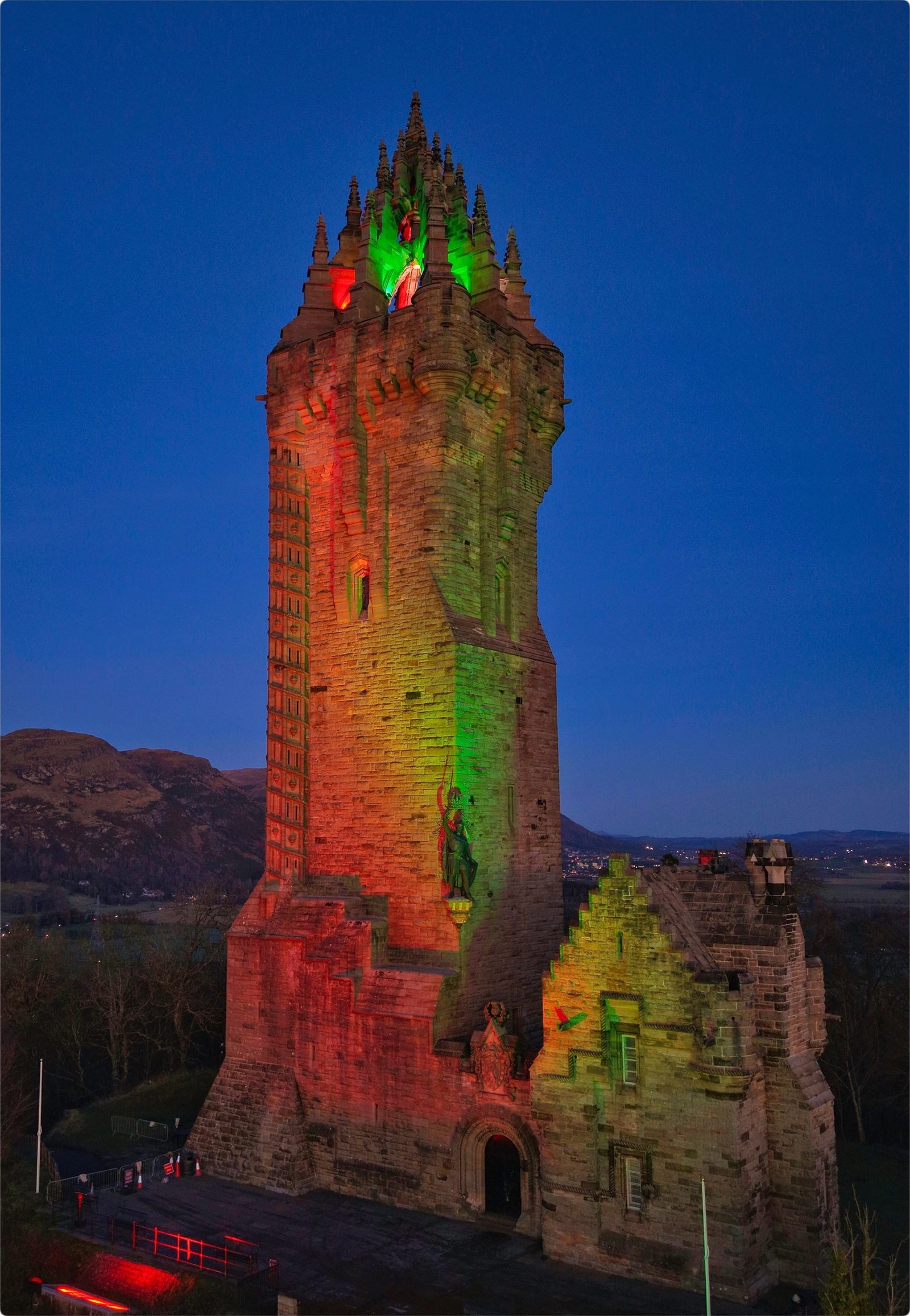 The National Wallace Monument lit green and red at night